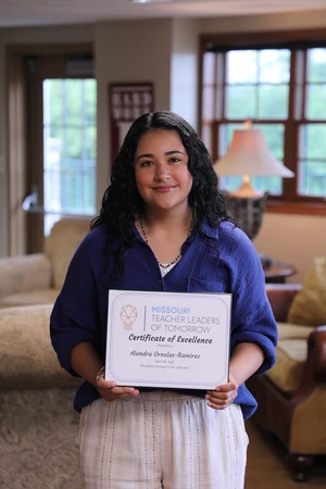 Woman smiling at camera with award